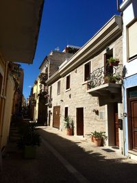 Buildings in city against blue sky