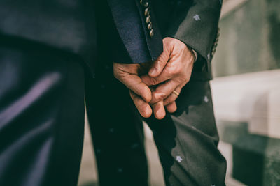 Close-up of hands holding leaf outdoors