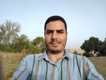 Portrait of smiling standing against clear sky