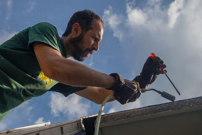 Low angle view of young man looking away