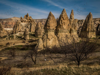 Rock formations on landscape against sky