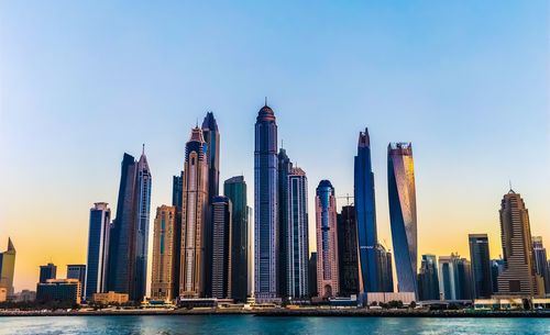 Skyscrapers in city against clear sky