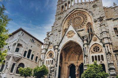 Low angle view of gothic style church of sant bartomeu de soller against sky