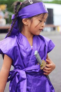 Close-up of girl holding blue head