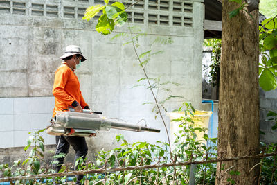 Man working on plant