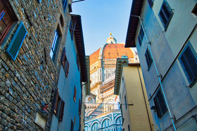 Low angle view of buildings against clear blue sky