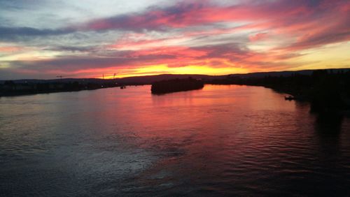 Scenic view of sea against dramatic sky during sunset