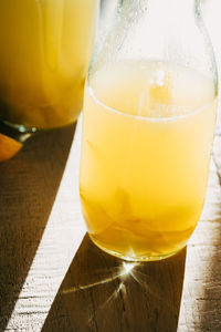 Close-up of limoncello in bottle on table