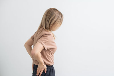 Rear view of woman standing against white background