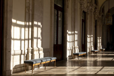 Empty chairs and table in building