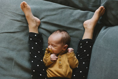 High angle view of baby sleeping on bed