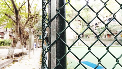 Close-up of chainlink fence in city