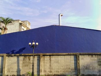 Low angle view of street light against building