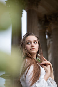 Portrait of young woman looking at camera