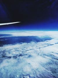 Cropped image of airplane flying over cloudscape