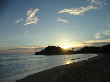 Scenic view of beach against sky during sunset