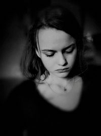 Close-up portrait of young woman looking down