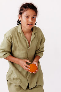Young woman using mobile phone against white background