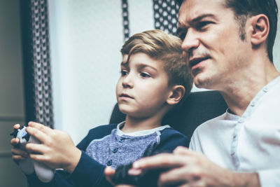 Portrait of father and son looking at camera