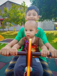 Cute boy sitting in garden