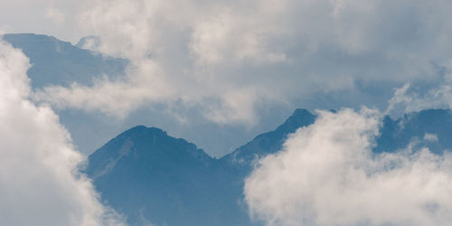 Low angle view of clouds over mountain