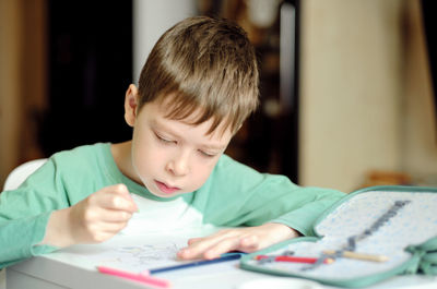 Close-up of cute girl studying at home