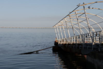 Pier over sea against clear sky