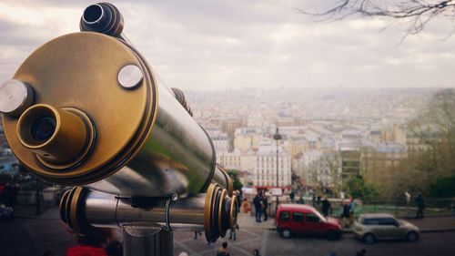 Close-up of telescope against cloudy sky