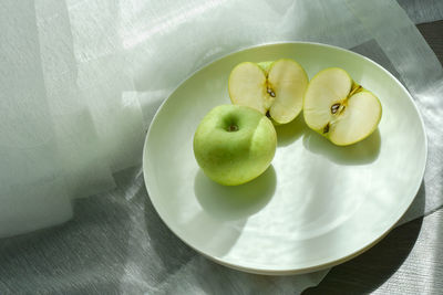 High angle view of apples in plate on table
