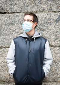 Midsection of man standing against wall
