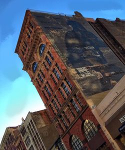 Low angle view of clock tower against sky