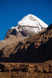 Scenic view of snowcapped mountains against clear blue sky