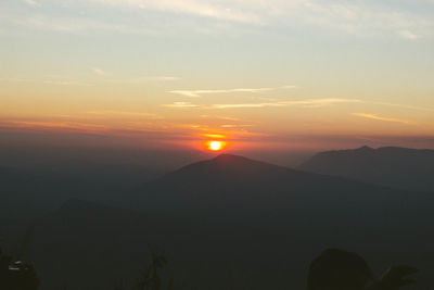 Scenic view of silhouette mountains against sky during sunset