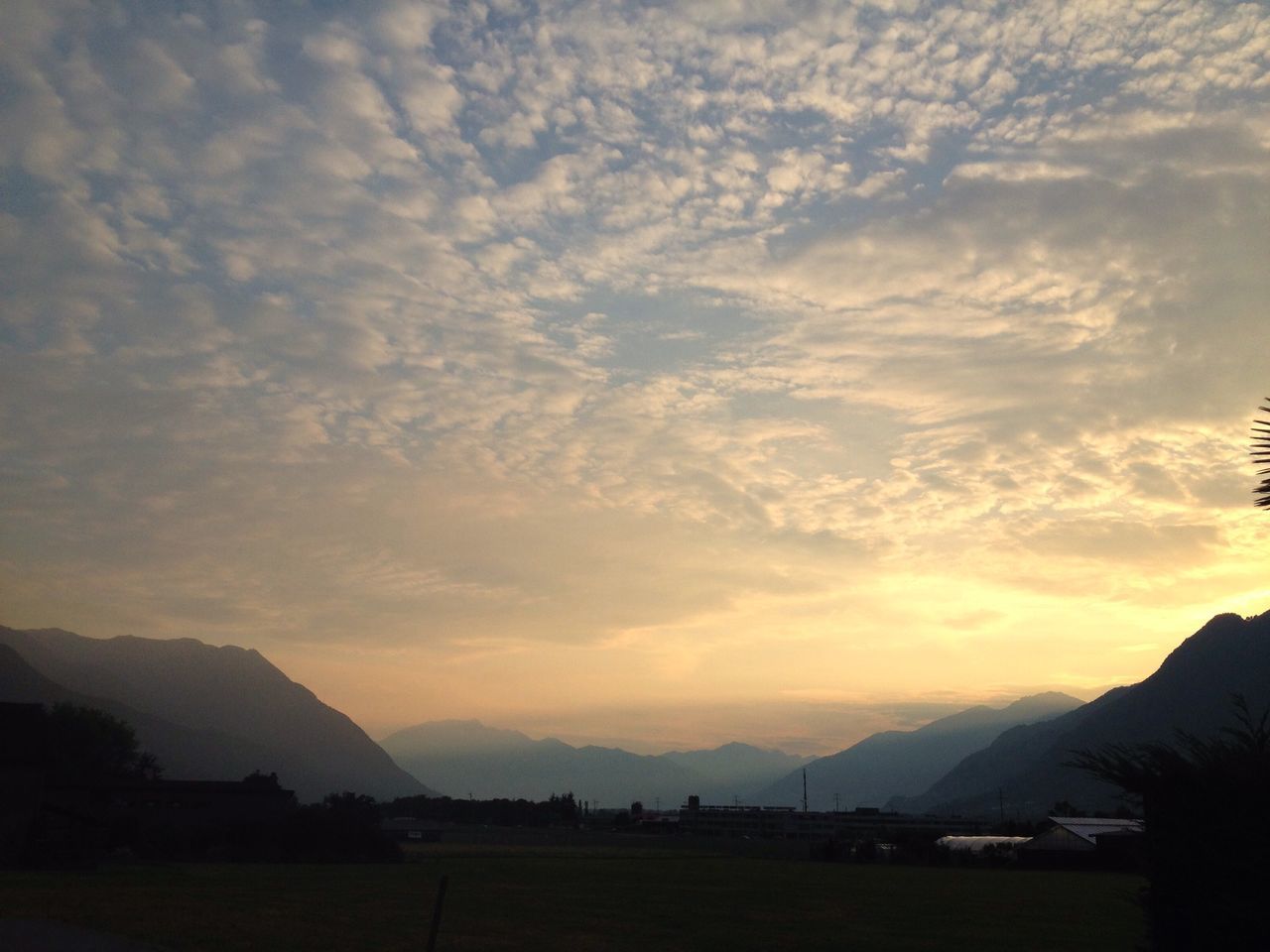 SCENIC VIEW OF MOUNTAINS AT SUNSET