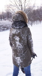 Person standing on snow covered landscape