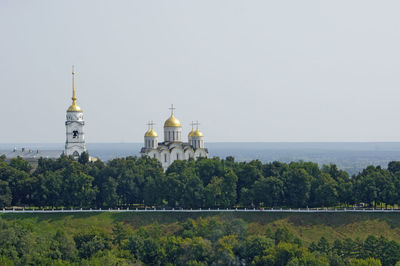 View of trees and building against sky