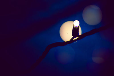 Close-up of illuminated lamp against black background