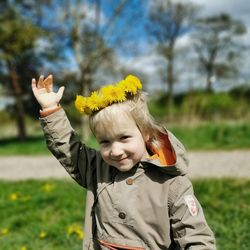 Portrait of a boy with a wreath of dandelions on his head