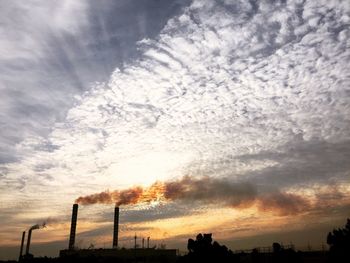 Low angle view of silhouette trees against sky