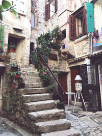 Low angle view of staircase amidst buildings