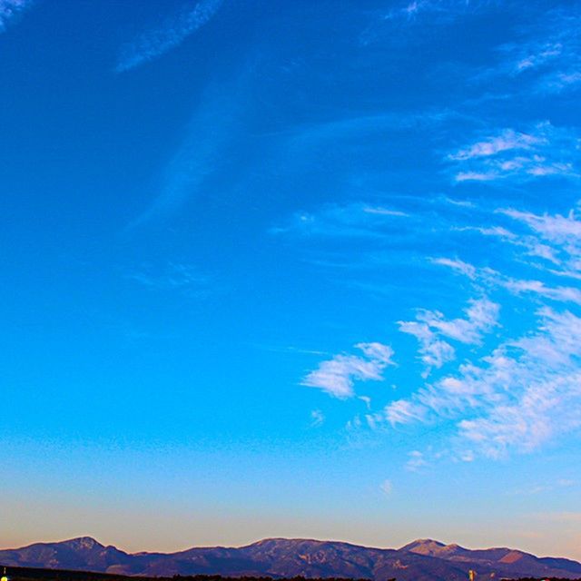 blue, mountain, scenics, tranquil scene, tranquility, beauty in nature, mountain range, nature, sky, low angle view, landscape, snow, idyllic, copy space, physical geography, majestic, non-urban scene, winter, snowcapped mountain, outdoors