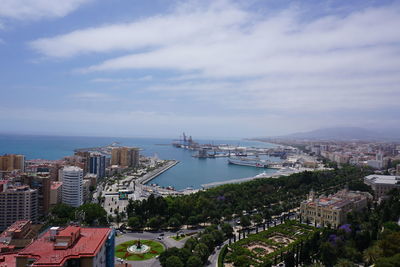 High angle view of buildings by sea against sky