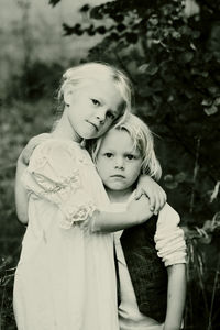 Portrait of mother with daughter standing outdoors