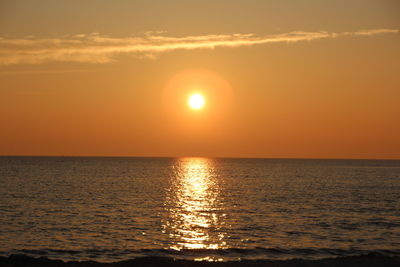 Scenic view of sea against orange sky