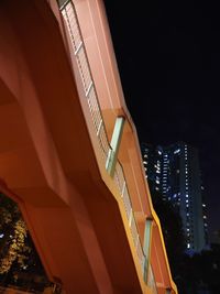 Low angle view of illuminated building against sky at night