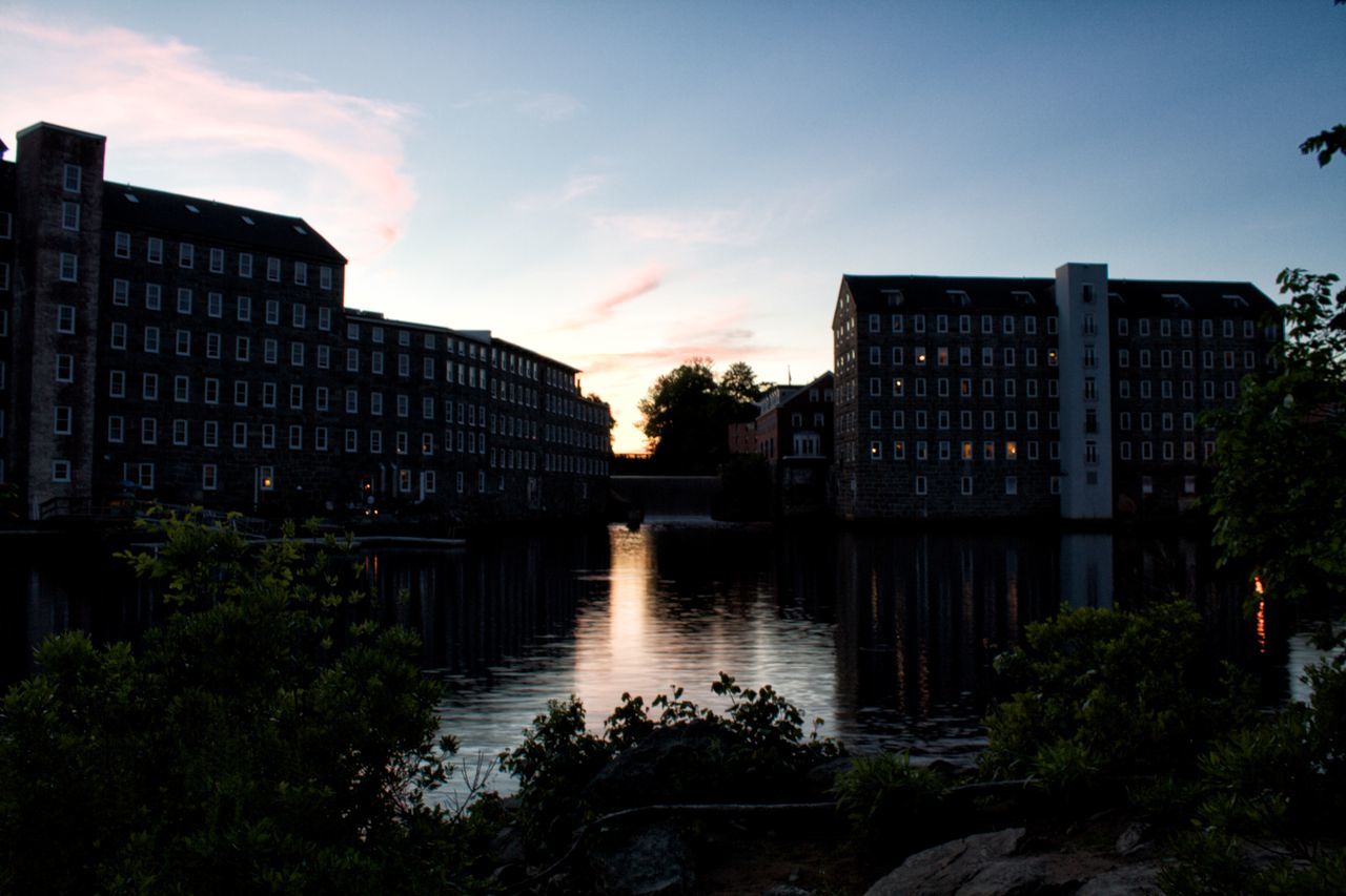 architecture, building exterior, built structure, sunset, water, sky, reflection, tree, city, river, building, canal, residential building, residential structure, outdoors, dusk, cloud - sky, no people, growth, orange color