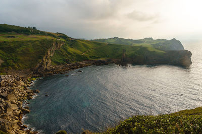 High angle view of sea and mountains against sky