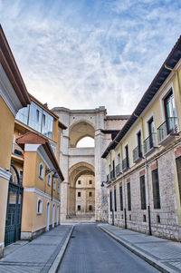 Street amidst buildings in city against sky