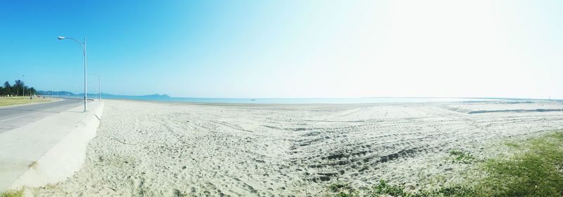 Scenic view of beach against clear blue sky