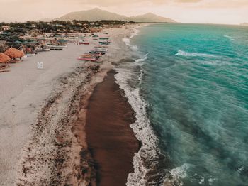 Scenic view of beach against sky at sunset